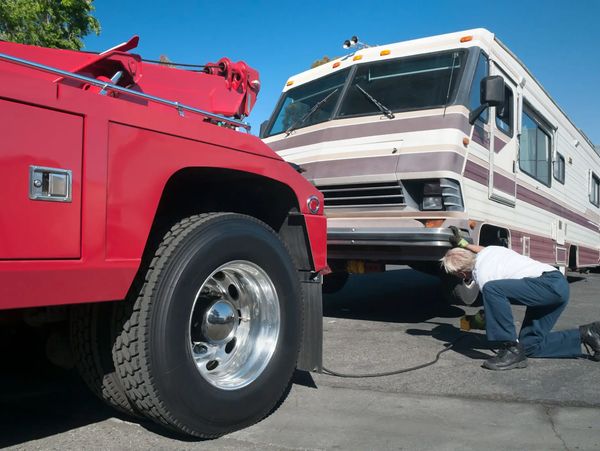 Tow truck driver assisting motorhome