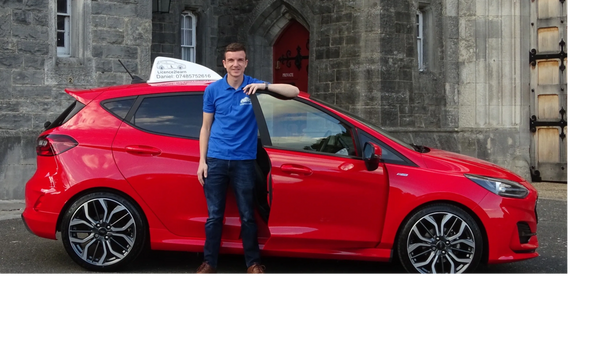 Driving Instructor Standing next to his car 