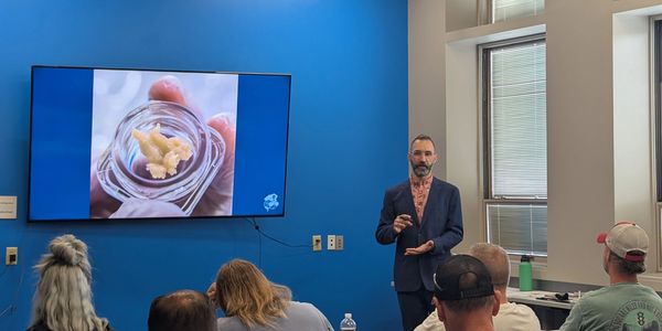 An instructor speaking to a group of students