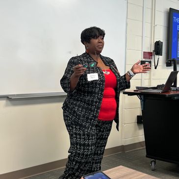 Woman speaking in a classroom.