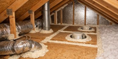 Insulated attic space with ducts and reflective insulation.