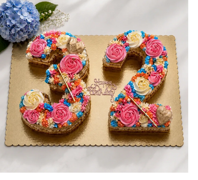 Colorful birthday cake shaped as number 32 with floral decorations.