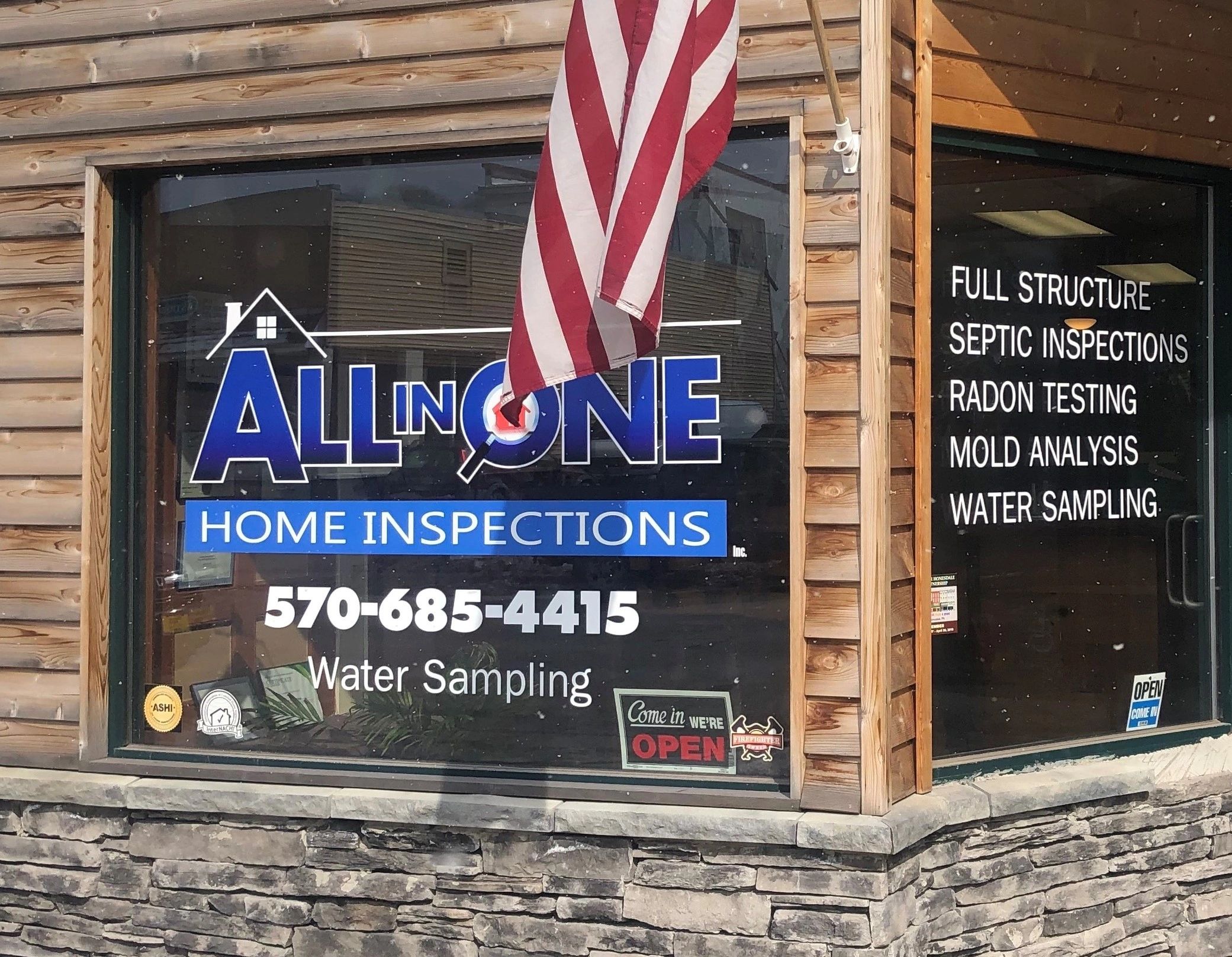 Home inspection business storefront with American flag and service details.