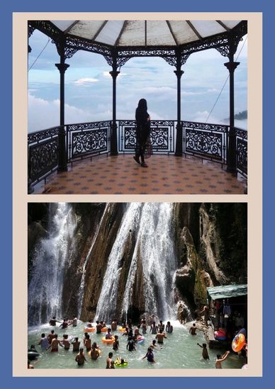 Person standing in a gazebo overlooking the sky and a crowded waterfall pool scene.
