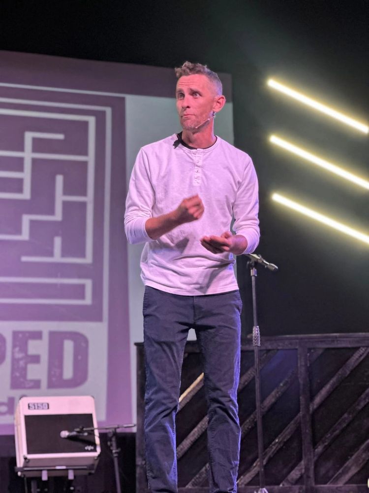 Stack of books next to pencils in a holder and a camera.