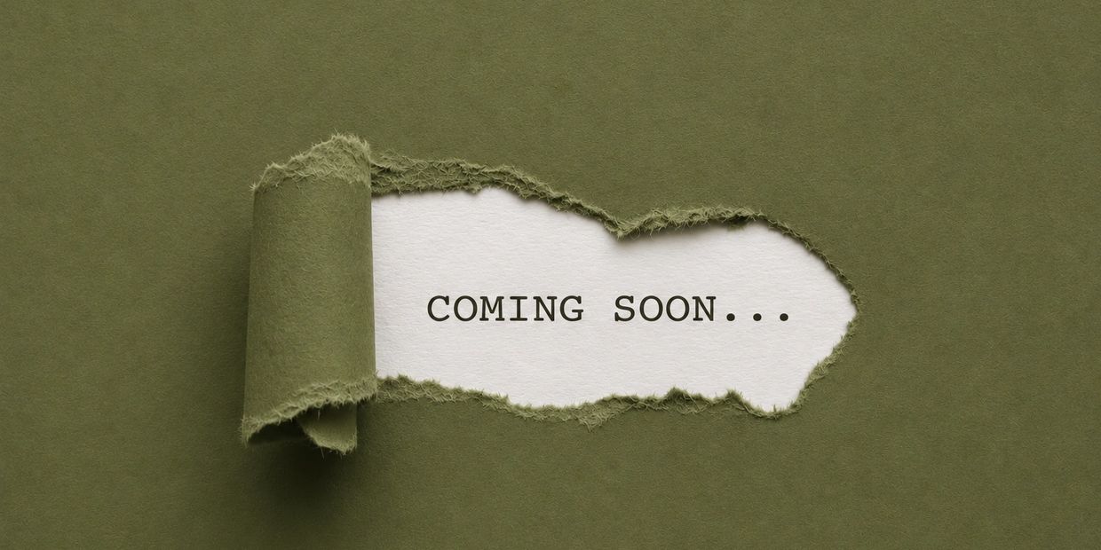 Torn green paper revealing the words 'COMING SOON...' underneath.