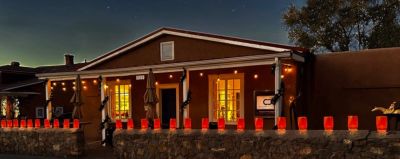 Cozy house with red lanterns lit at night.