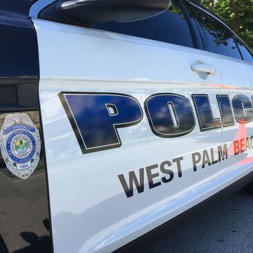 Side view of a West Palm Beach police car with badge and logo.
