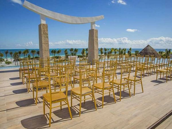 Outdoor seating setup overlooking the ocean under a clear sky.