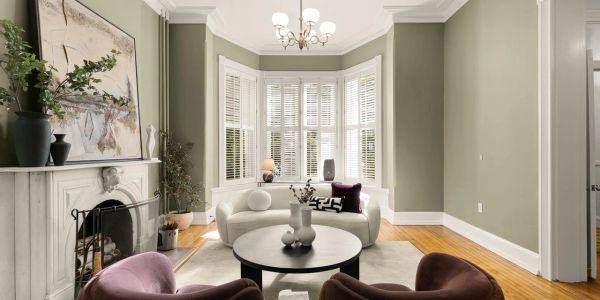 Elegant living room with curved sofa and large windows.
