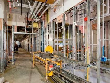 Interior of a building under construction with metal framing and tools.