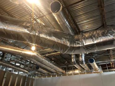 Ductwork attached to the roof, crafted to manufacturer specs for optimal performance and airflow.