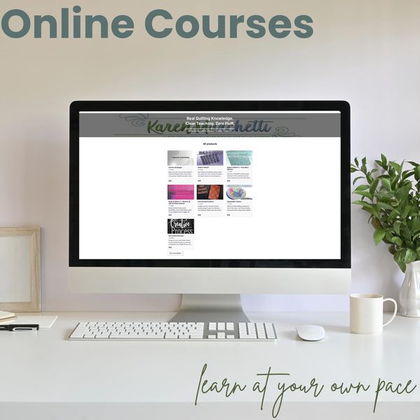Computer screen displaying online quilting courses on a clean desk.