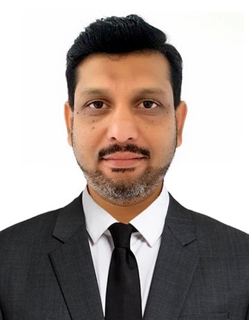Man in a black suit and tie.