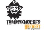 Logo for Tommyknocker Brewery with a smiling miner.