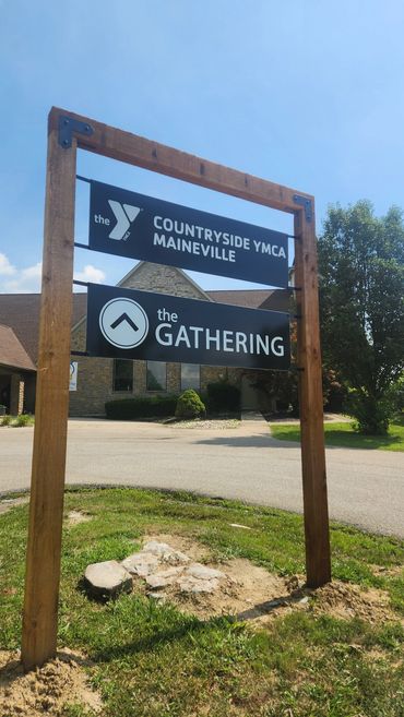 New cedar ruff cut plank sign structure with floating poly metal panels.