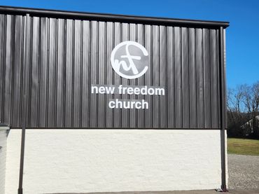 CNC Cut PVC logo and lettering mounted to poly metal panels. Flush mounted to steel building.