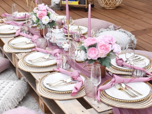 A pink themed picnic style set up outdoors