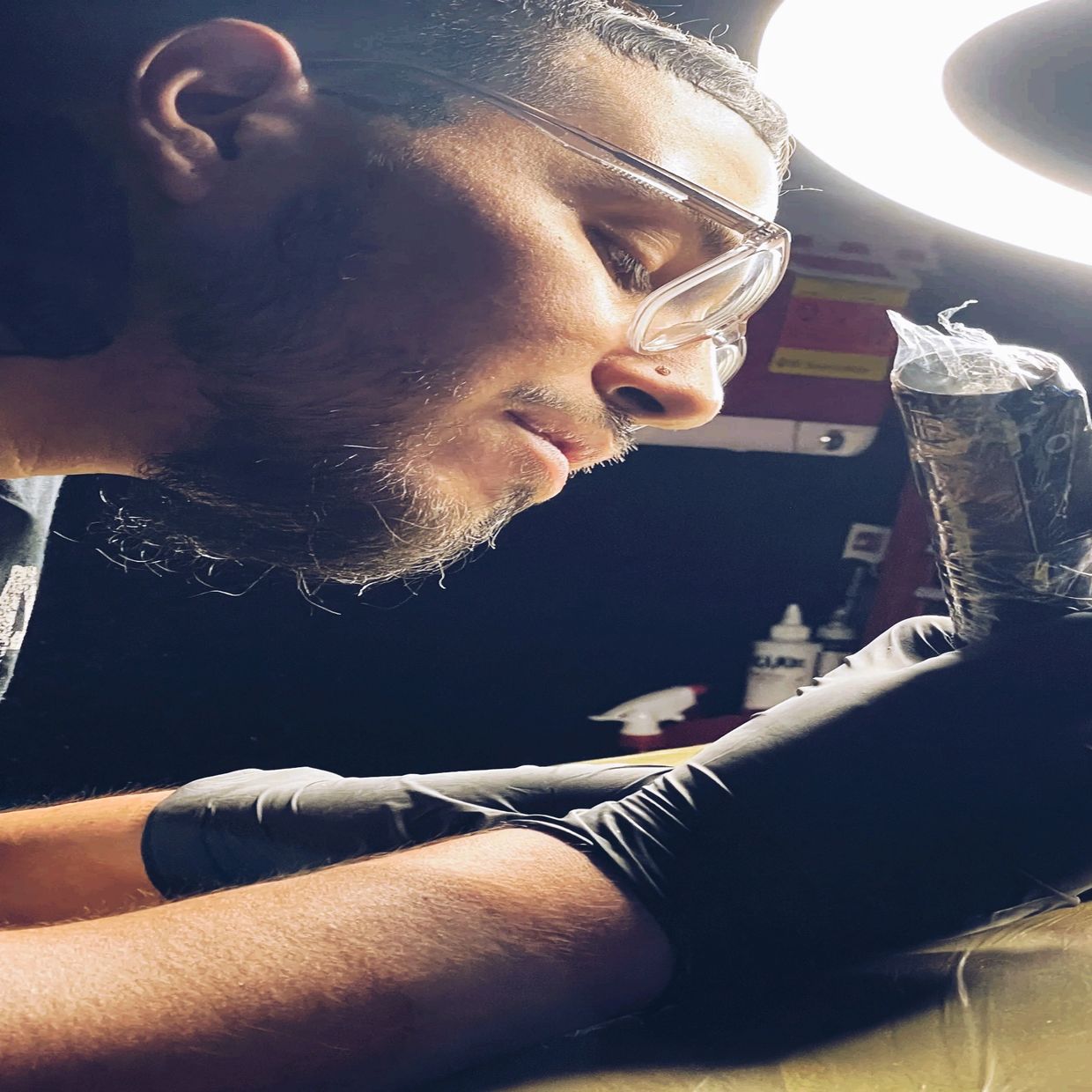 a tattoo artist tattooing