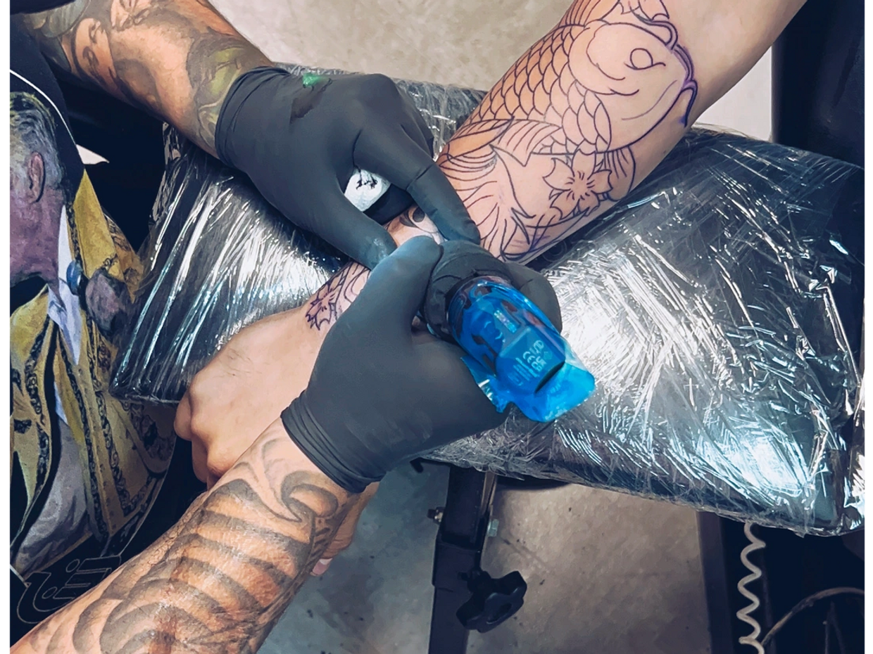 a tattooer tattooing