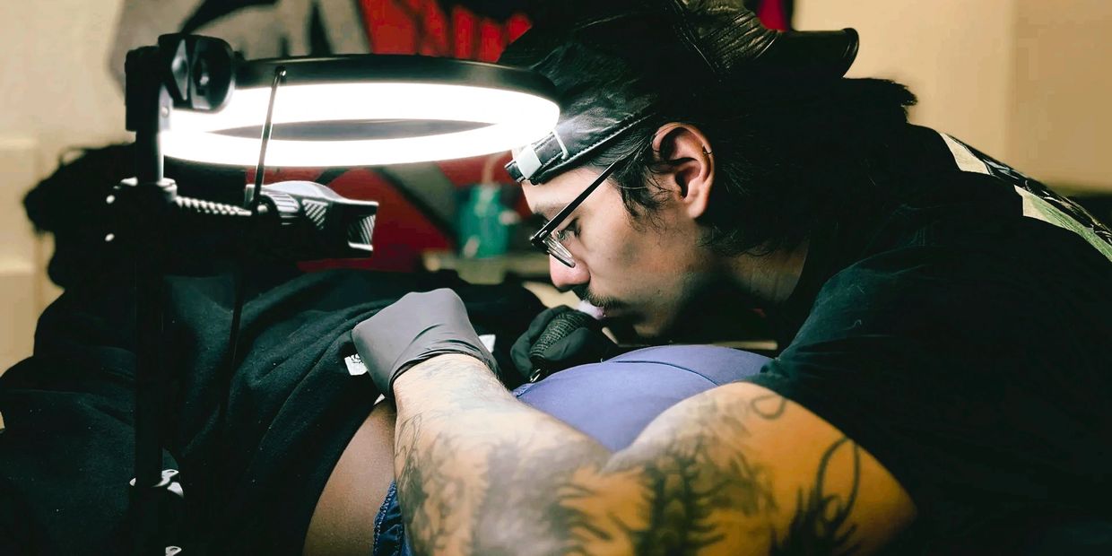 a tattoo artist tattooing