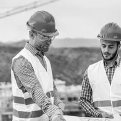 Two construction workers reviewing plans.