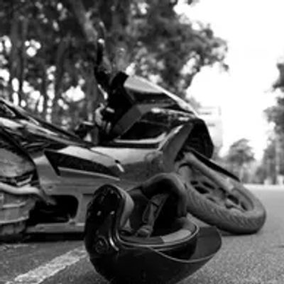 A motorcycle accident with a helmet on the road.