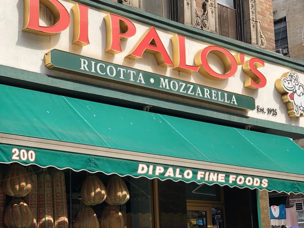 Storefront of Dipalo's Fine Foods with green awning.