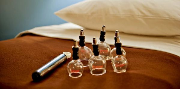 small cupping cups used in acupuncture on a treatment bed