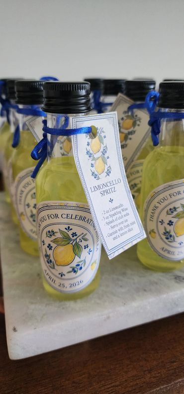 Mini bottles of Limoncello Spritz with thank you labels and recipe tags.