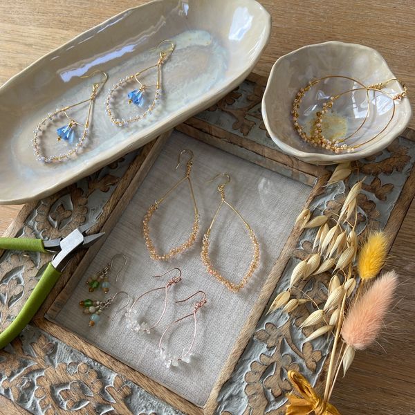 Beautiful Bohemia jewellery on a wooden Indian carved frame with dried flowers. 