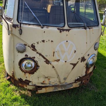 Rusty vintage Volkswagen van front.
