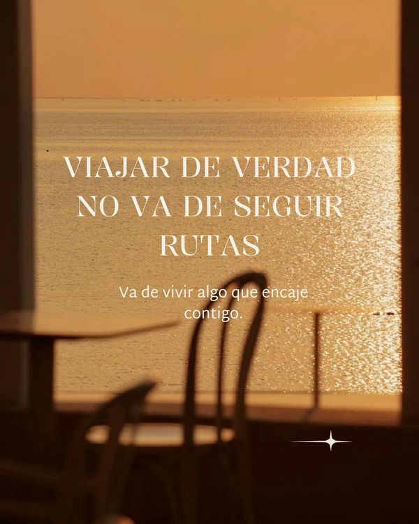 Inspirational travel quote over a serene sunset sea view with chairs in foreground.