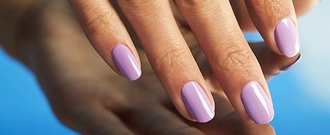 closeup shot of hand model wearing lavender nail polish