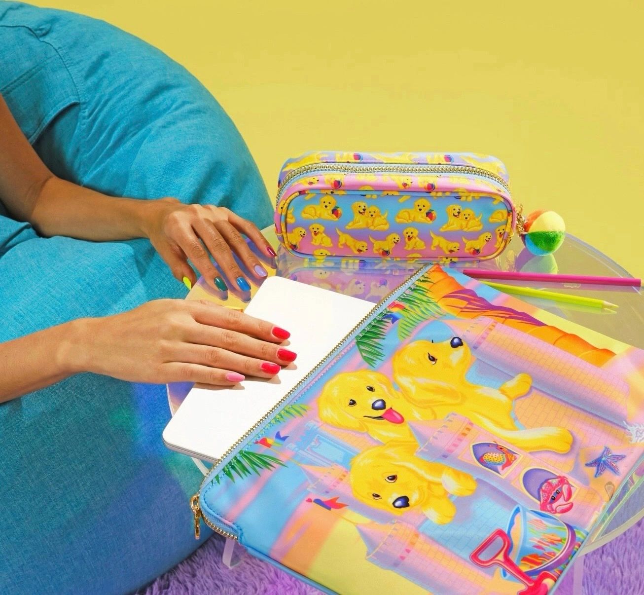 hand model pulling out computer from y2k lisa frank bag