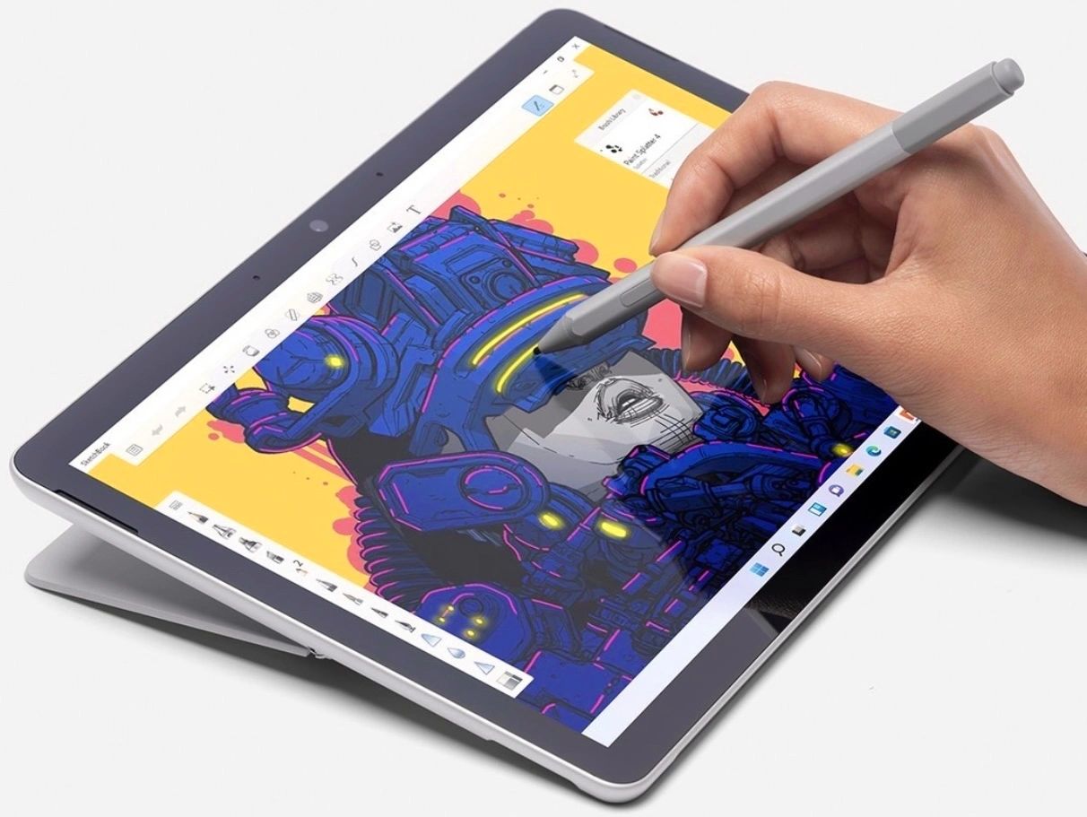 graphic designer hand model holding digital pen drawing yellow line across tablet device