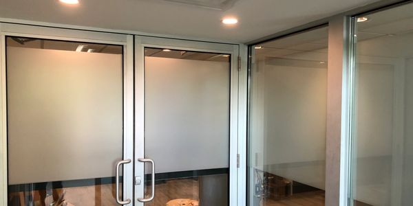 Before and after commercial window tint installation showing reduced glare and improved privacy.