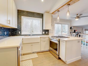 New Brighton kitchen remodel w/ farmhouse sink and navy blue backsplash.  Cambria Sutherland quartz