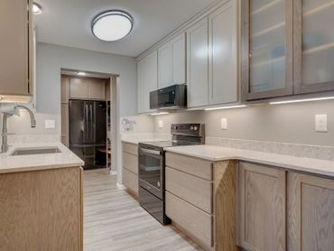 Condo Kitchen Remodel with oak cabinets and quartz counters.  Extended storage.