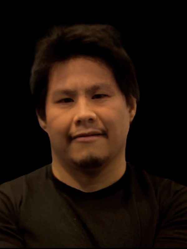 Portrait of a man with dark hair and a black shirt.