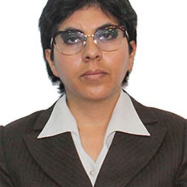Professional portrait of a person wearing glasses and a suit.
