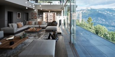 Modern living room with glass wall offering mountain views.