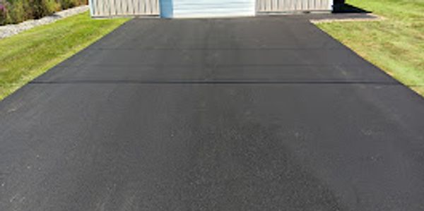 Freshly paved driveway on Harsens Island—quality asphalt work by Baker Asphalt & Sealcoating.