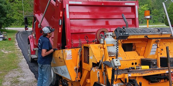 Loading hot asphalt into the paver—precision paving by Baker Asphalt in St. Clair County,