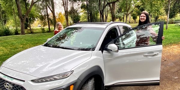 student and instructor getting into car to drive. driving school near me. 