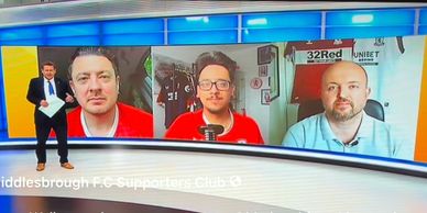 TV presenter with three guests on a sports talk show screen.