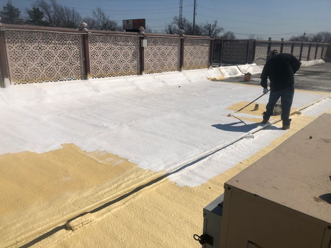 Silicone roof coating applied over polyurethan spray foam roof system.