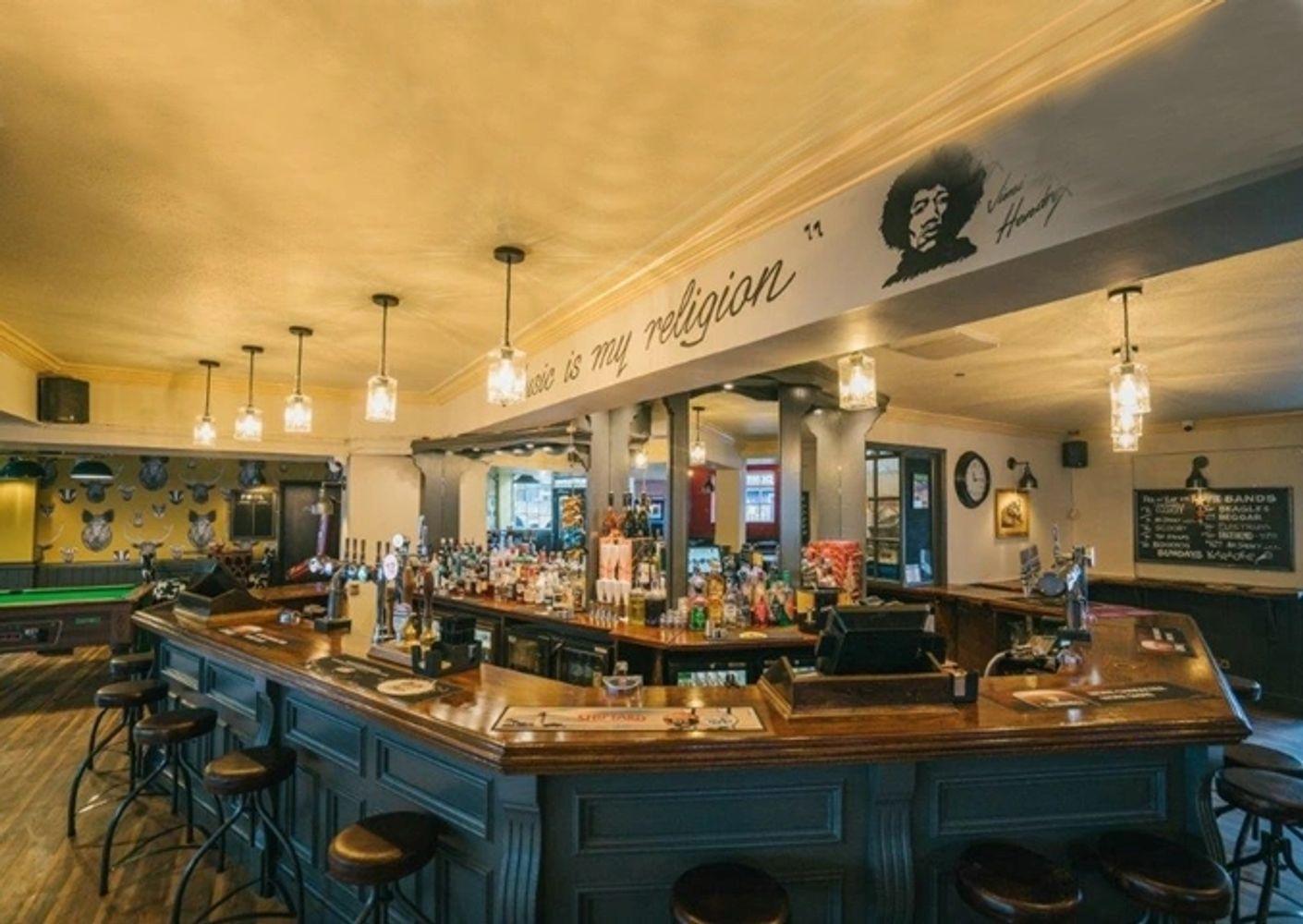 Empty bar with a Jimi Hendrix quote above the counter.