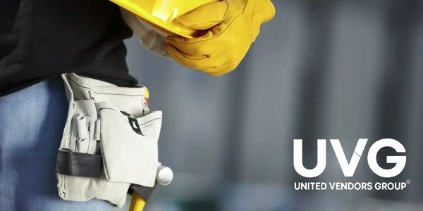 Worker holding helmet with tool belt, UVG logo.