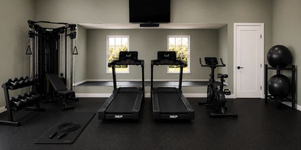 Modern home gym with treadmills and weights.